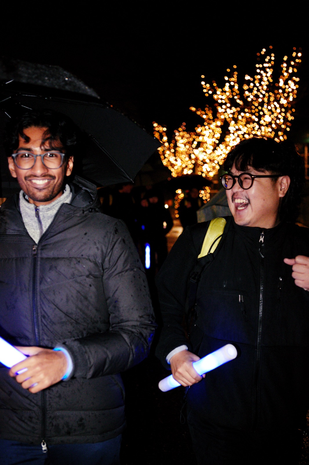 Two members with glow sticks at the night event