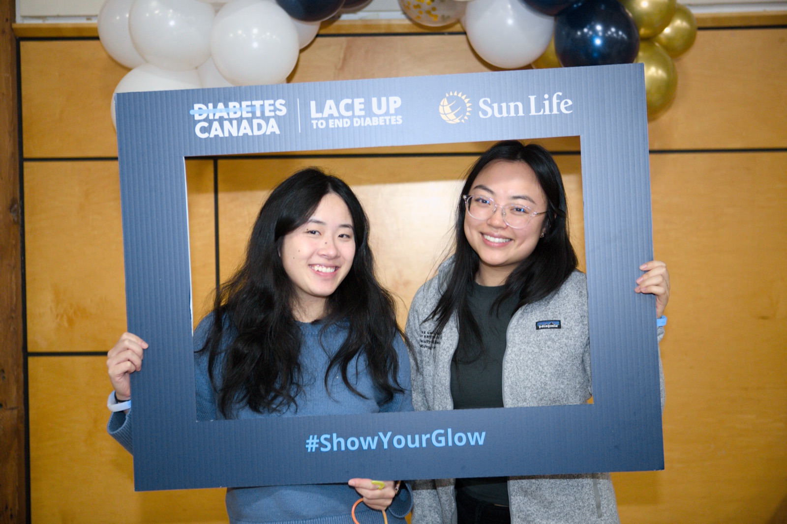 Two members holding the Diabetes Canada Lace Up photo frame