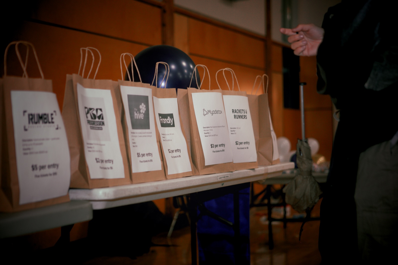 Sponsor gift bags lined up on a table